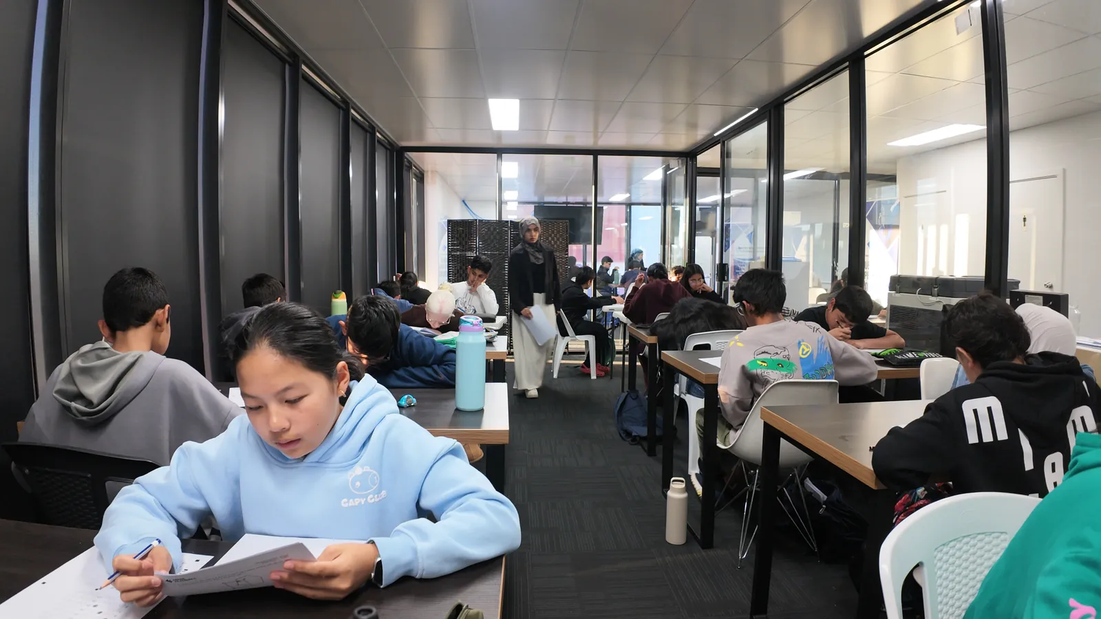 Students sitting a full Selective Entry mock exam at the Aspire centre while a tutor supervises