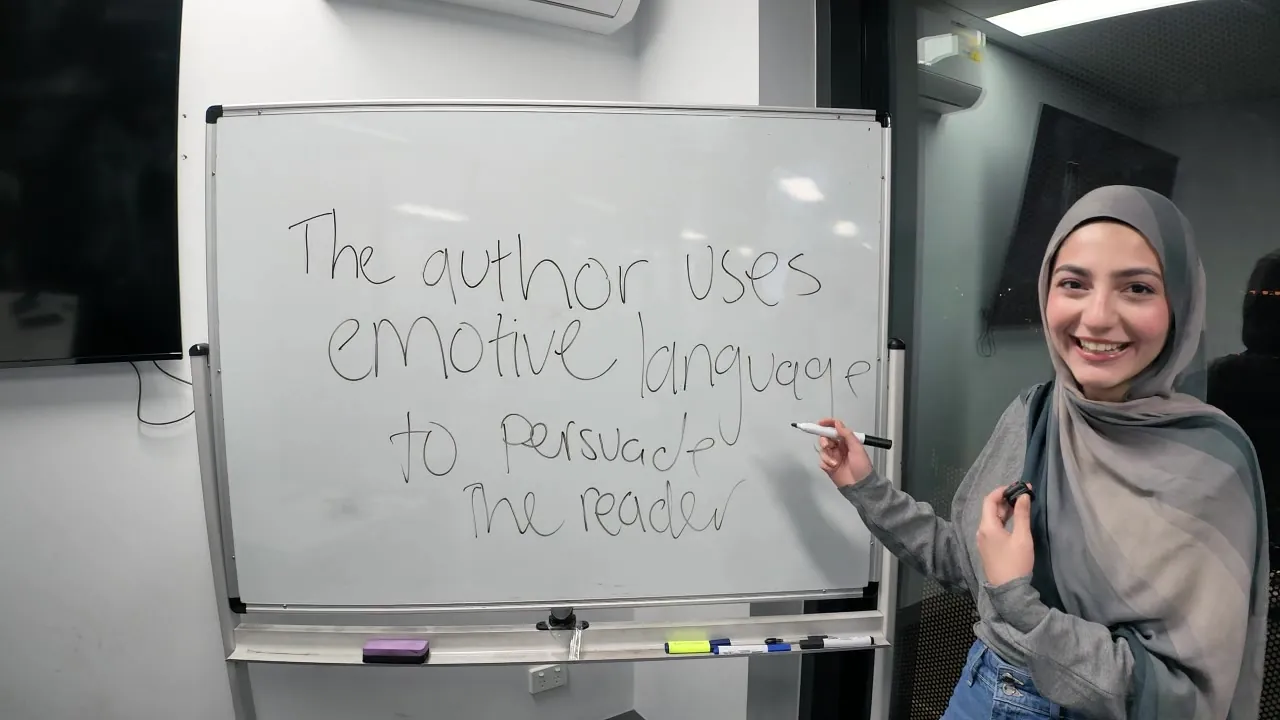An Aspire tutor explaining persuasive language at the whiteboard