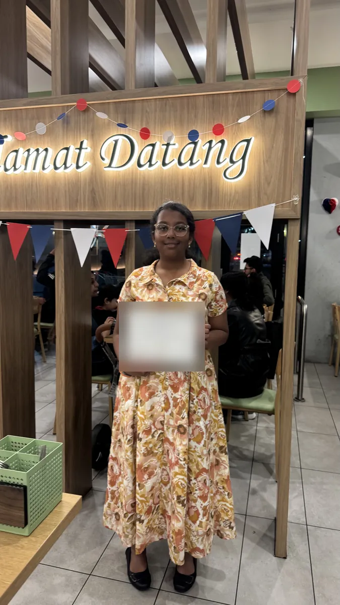An Aspire student holding a certificate at the 2026 Selective Entry dinner