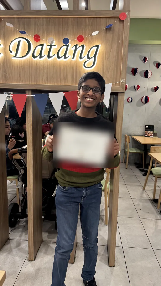 An Aspire student holding a certificate at the 2026 Selective Entry dinner